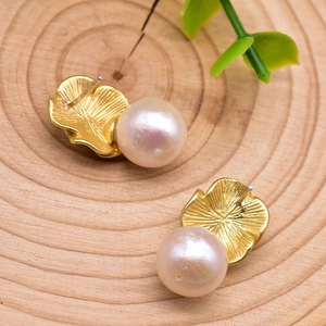 Detail of S925 silver stamp on gold flower petal earring with natural pearl