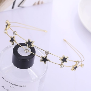 Detail view of double-layer golden headband with black star accents and sparkling rhinestones