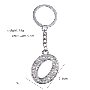 Silver letter O keychain with rhinestones, size 3.6x3cm and weight 14g on white background