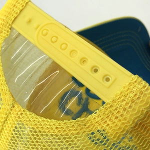 Detail of adjustable snapback closure and breathable yellow mesh on the trucker hat