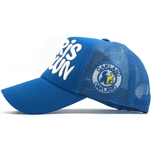 Detail showing 3D white embroidery and side badge on a breathable blue mesh trucker hat