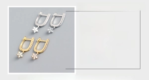 Detail view of S925 sterling silver U-shaped earrings with sparkling star charms