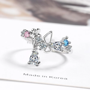 Silver bow flower ring with pink and blue crystals in a minimalist open design