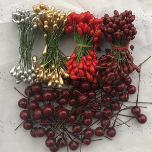 Close-up of DIY decorative metallic berries and stamens for wedding gift boxes