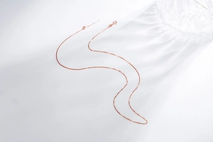 Detail of rose gold box chain with needle tip and lobster clasp for small hole pendants