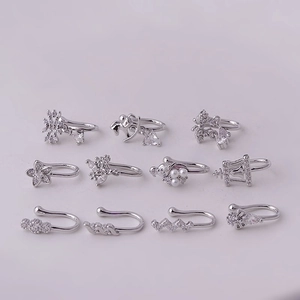 Set of 11 silver nose clips with micro-paved zircons and pearls on pink background