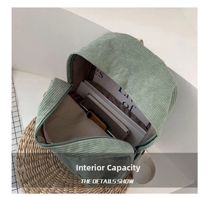 Spacious interior of light green corduroy backpack showing large capacity for A4 books