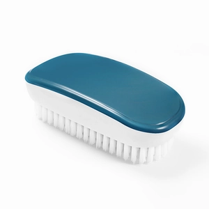 Blue plastic shoe brush with dense white bristles for home cleaning on white background