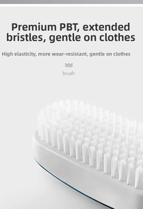 Detailed macro view of high-quality long PBT bristles on a white laundry cleaning brush