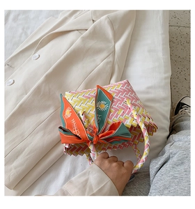 Detail of colorful woven tote bag with silk scarf ribbon and handmade texture