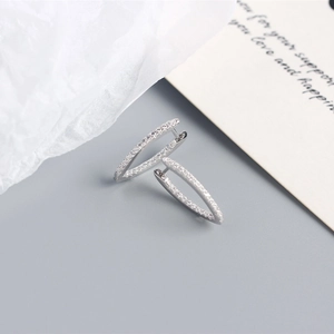 Macro detail of S925 sterling silver hoop earrings with pave-set white cubic zirconia