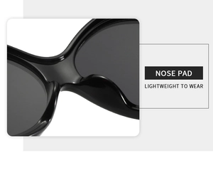 Detail view of smooth integrated nose pads on black oversized fashion sunglasses