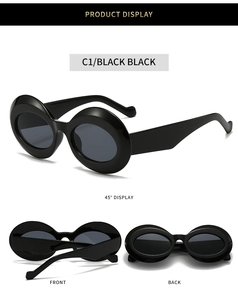 Detail view of oval thick-frame sunglasses in glossy black with dark grey lenses
