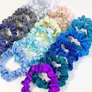 Set of colorful satin silk scrunchies with elastic pleated design in various vibrant shades