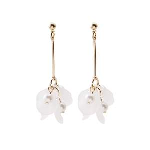 Close-up of elegant gold earrings with white translucent petals and delicate pearls