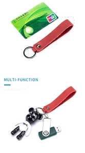 Detail of red genuine leather keychain with silver metal ring and sleek hardware