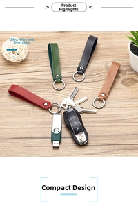 Detail of four colorful leather keychains with silver rivets on a wooden table