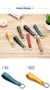 Detailed close-up of multi-color genuine leather car keychains with metal ring attachments