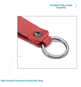 Detail of red genuine leather keychain featuring a polished metal ring and secure rivet