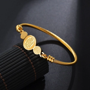 Gold stainless steel cable wire bracelet featuring Virgin of Guadalupe religious charms