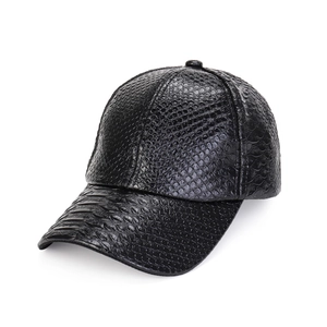Detailed close-up of a black PU leather baseball cap with a textured snakeskin pattern