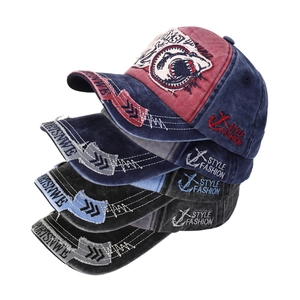 Detailed stack of washed cotton baseball caps with shark patches and vintage textures