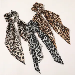 Three-pack leopard print satin scrunchies with long ribbons in brown and cream tones
