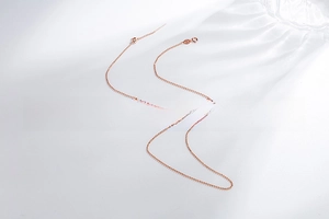 Polished rose gold S925 sterling silver ball chain with spring clasp on white background