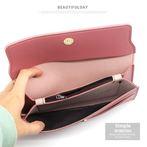 Detail view of pink long wallet interior with magnetic buckle and multi-card slots