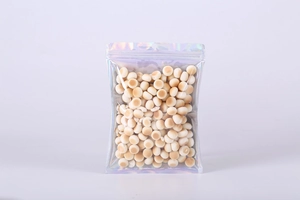 Detailed view of standing holographic laser zip bag filled with cookies on white background