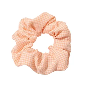 Pastel orange plaid scrunchie for ponytails featuring high-quality fabric texture