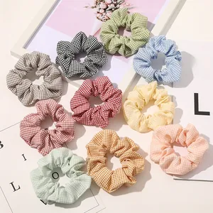 Close-up of 10 pack colorful plaid scrunchies in soft macaron tones with fine fabric texture