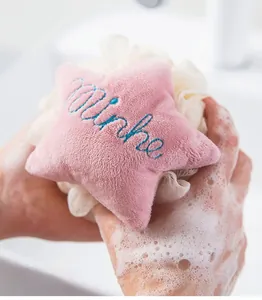Close-up of star-shaped bath sponge creating rich foam during personal cleaning