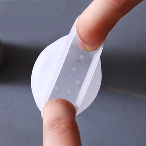 Elastic white silicone chair leg protector being stretched to show high flexibility