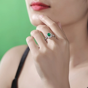 Elegant 925 silver open ring featuring an oval green gemstone with halo diamonds