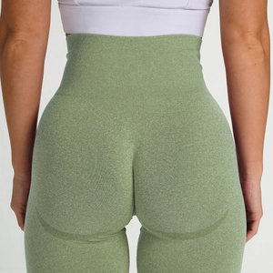 Close-up of seamless marl knit fabric and high-waist band on green yoga leggings