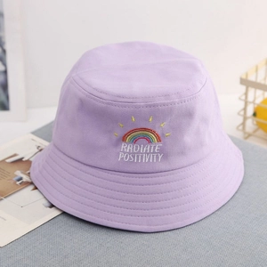 Lavender kids bucket hat with rainbow embroidery and 'RADIATE POSITIVITY' text detail