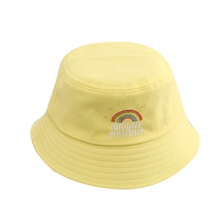 Yellow kids cotton bucket hat with rainbow embroidery and Radiate Positivity text