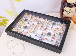 Detailed view of a black ring display box with 100 slots and a clear glass lid