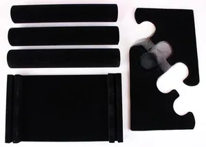 Disassembled black velvet jewelry display stand components with base and three cylinder rods
