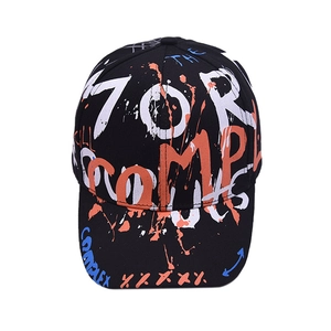 Close-up of street style graffiti print and paint splashes on a black cotton baseball cap