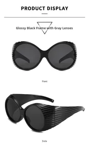 Detail view showing large black frame sunglasses with textured wide temples and grey lenses