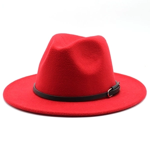 Detailed view of red fedora hat with elegant black band and silver buckle detail