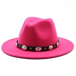 Close-up of pink wool fedora hat featuring black leather band and silver metal studs