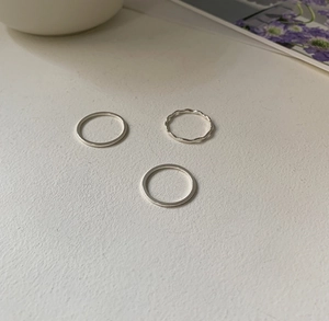 Detailed view of 925 sterling silver ring set including wavy and minimalist smooth bands
