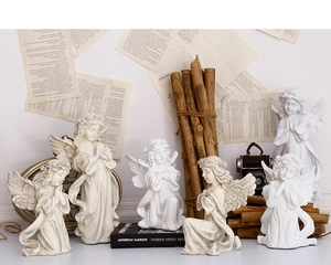 Macro detail of six vintage resin angel figurines in ivory white with artistic poses