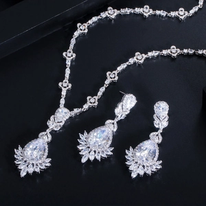 Exquisite silver bridal jewelry set with sparkling zircon necklace and earrings on black background