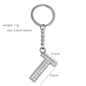 Detailed close-up of rhinestone letter T keychain with silver metal dimensions info