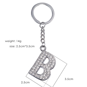 Silver metal letter B keychain with sparkling rhinestones on a white background