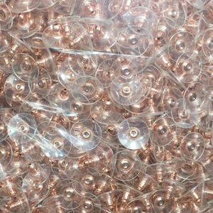 Close-up of bulk rose gold bullet clutch earring backs with clear plastic pads